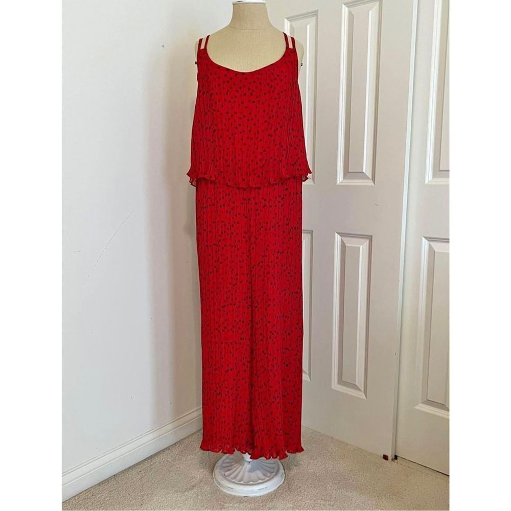 Red jumpsuit with black polka dots. Crisscross back with adjustable straps. New